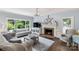 Bright living room with a brick fireplace, large windows, and comfortable seating at 5517 Alexa Rd, Charlotte, NC 28277