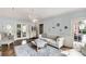 Inviting living room with tufted sofa, ottoman, and classic decor at 5517 Alexa Rd, Charlotte, NC 28277