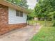 Fenced backyard with a storage shed and mature trees, perfect for outdoor activities at 5629 Ruth Dr, Charlotte, NC 28215