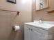 Well-lit bathroom with a white vanity, a modern sink, and a convenient toilet paper holder at 5629 Ruth Dr, Charlotte, NC 28215
