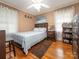 Relaxing bedroom featuring a large bed, wood floors, natural light, and tasteful decor at 5629 Ruth Dr, Charlotte, NC 28215