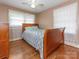 Cozy bedroom with a comfortable queen-sized bed and beautiful hardwood floors at 5629 Ruth Dr, Charlotte, NC 28215