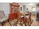 Bright dining area with a wooden table set, a china cabinet, and neutral-toned walls at 5629 Ruth Dr, Charlotte, NC 28215