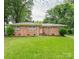 Charming single-story brick home featuring a lush green lawn and mature trees at 5629 Ruth Dr, Charlotte, NC 28215