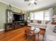 Inviting living room featuring hardwood floors, a ceiling fan, and comfortable seating at 5629 Ruth Dr, Charlotte, NC 28215