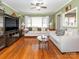 Inviting living room featuring hardwood floors, a ceiling fan, and abundant natural light at 5629 Ruth Dr, Charlotte, NC 28215