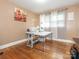 Bright spare room with hardwood floors, featuring a sewing machine and natural light from the windows at 5629 Ruth Dr, Charlotte, NC 28215