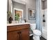 Charming bathroom featuring a wooden vanity, white countertops, and a stylish shower with gray shower curtain at 5731 Castlerea Dr, Charlotte, NC 28217