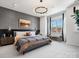 Spacious bedroom features textured wall, modern lighting, and large window at 5731 Castlerea Dr, Charlotte, NC 28217