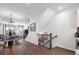 Bright hallway with hardwood floors, modern lighting, and staircase leading to the upper level at 5731 Castlerea Dr, Charlotte, NC 28217