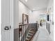 Second floor hallway with modern railing and views to adjacent exercise room at 5731 Castlerea Dr, Charlotte, NC 28217