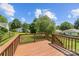 Back deck of a home overlooking a green backyard with wooden fencing at 613 Church St, Belmont, NC 28012