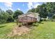 A house with a back deck is surrounded by a lush yard at 613 Church St, Belmont, NC 28012