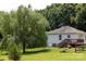 Backyard with a house, a deck and a large shade tree at 613 Church St, Belmont, NC 28012