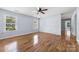 Inviting bedroom with wood-look floors, neutral walls, ceiling fan, and natural light from double-hung windows at 613 Church St, Belmont, NC 28012