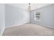 Bedroom featuring neutral walls and carpet, window, and double-door closet at 613 Church St, Belmont, NC 28012