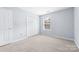 Small bedroom featuring neutral walls and carpet, and double-door closet at 613 Church St, Belmont, NC 28012