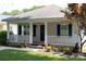 Home with a charming front porch, white railings and dark green shutters at 613 Church St, Belmont, NC 28012