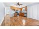 Open kitchen with wood cabinets, stainless steel appliances, and wood-look floors flowing into the adjacent space at 613 Church St, Belmont, NC 28012