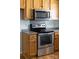 Well-equipped kitchen featuring stainless steel appliances and light wood cabinetry at 613 Church St, Belmont, NC 28012