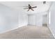 Large main bedroom featuring a ceiling fan, carpet, and ensuite bathroom at 613 Church St, Belmont, NC 28012
