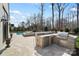 Outdoor kitchen with grill, refrigerator, and granite countertops next to a pool and spa at 7215 Alexander Rd # 4, Charlotte, NC 28270