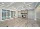 Finished basement with a stone fireplace and sliding glass door to the backyard at 7215 Alexander Rd # 4, Charlotte, NC 28270