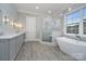 Modern bathroom featuring a glass enclosed shower, soaking tub, double vanity and stylish lighting at 7215 Alexander Rd # 4, Charlotte, NC 28270