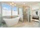 Marble bathroom with a soaking tub, glass shower and view of the backyard pool at 7215 Alexander Rd # 4, Charlotte, NC 28270