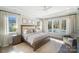 Bright bedroom featuring a neutral color palette, ceiling fan, and backyard pool view at 7215 Alexander Rd # 4, Charlotte, NC 28270