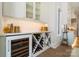 Butler's pantry with a wine cooler, white cabinets, glass shelving, and countertop space at 7215 Alexander Rd # 4, Charlotte, NC 28270