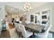 Open-concept dining room featuring a large table, elegant chandelier, and plenty of natural light at 7215 Alexander Rd # 4, Charlotte, NC 28270