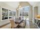 Bright dining room with a large window overlooking the backyard, chandelier and wooden table at 7215 Alexander Rd # 4, Charlotte, NC 28270