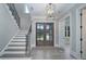 Grand foyer with hardwood floors, staircase, and modern lighting fixtures at 7215 Alexander Rd # 4, Charlotte, NC 28270