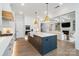 Modern kitchen with an oversized island, stainless steel appliances, and hardwood flooring at 7215 Alexander Rd # 4, Charlotte, NC 28270