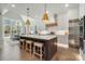 Chef's kitchen with an island, counter seating, stainless appliances, and bright natural light at 7215 Alexander Rd # 4, Charlotte, NC 28270
