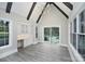 Living area featuring a vaulted ceiling with wooden beams, built-in cabinetry, and a view of the pool at 7215 Alexander Rd # 4, Charlotte, NC 28270