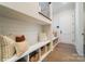 Mudroom features built-in shelves, storage baskets, bench, and hardwood floors at 7215 Alexander Rd # 4, Charlotte, NC 28270