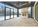 Enclosed patio featuring a stone fireplace, concrete floor, and large windows with backyard views at 7215 Alexander Rd # 4, Charlotte, NC 28270