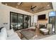Comfortable covered patio with fireplace, TV, and sliding glass doors that open to the pool at 7215 Alexander Rd # 4, Charlotte, NC 28270