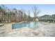 Backyard with a large in-ground swimming pool and a spa surrounded by stone pavers and trees at 7215 Alexander Rd # 4, Charlotte, NC 28270