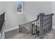 Staircase featuring a black iron railing, wooden steps, and a window at the landing at 7215 Alexander Rd # 4, Charlotte, NC 28270