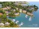 Waterfront community aerial view featuring a private marina and various residential buildings along the coast at 753 Southwest Dr, Davidson, NC 28036