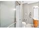 Tiled shower enclosure in a bathroom featuring a white toilet and modern vanity at 753 Southwest Dr, Davidson, NC 28036