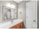Bathroom featuring a white sink, wooden cabinet and a view of a toilet and bathtub at 753 Southwest Dr, Davidson, NC 28036