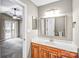 Bathroom featuring a wooden vanity, large mirror and view into the main bedroom at 753 Southwest Dr, Davidson, NC 28036