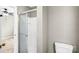 Bathroom with tiled shower, toilet, and doorway to a bedroom with gray carpet at 753 Southwest Dr, Davidson, NC 28036