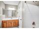 Bathroom featuring a white tiled shower, wooden vanity and view into the main room at 753 Southwest Dr, Davidson, NC 28036
