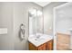 Well-lit bathroom with a modern vanity, mirror, and open doorway to a bright room at 753 Southwest Dr, Davidson, NC 28036