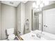 Bathroom showcasing a toilet, vanity, modern lighting, and mirror at 753 Southwest Dr, Davidson, NC 28036